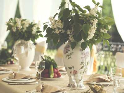 Classy table setting with elegant china, silverware, and crystal glasses designed by On Board Catering for an event in Raleigh.